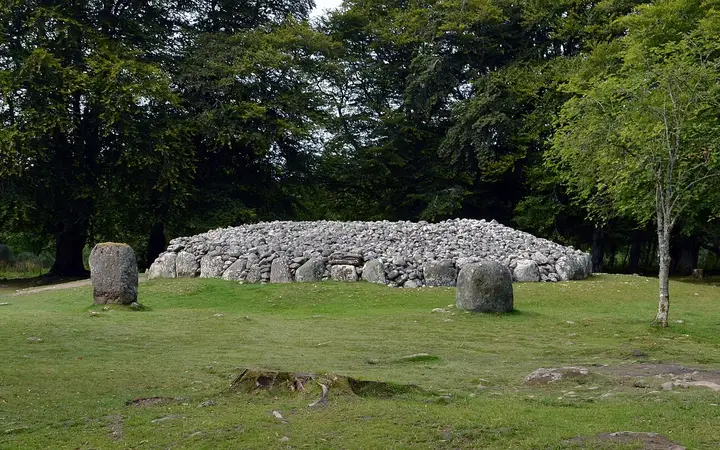 A stone circle and ring cairn at the Clava Cairns among trees
