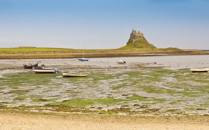 Lindisfarne Castle on its rocky crag above the tidal flats of Holy Island