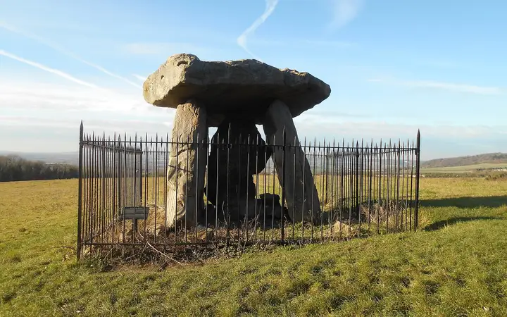 Kit's Coty House, three upright stones and a capstone behind railings
