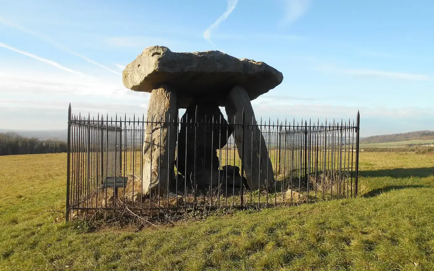 Kit's Coty House, three upright stones and a capstone behind railings