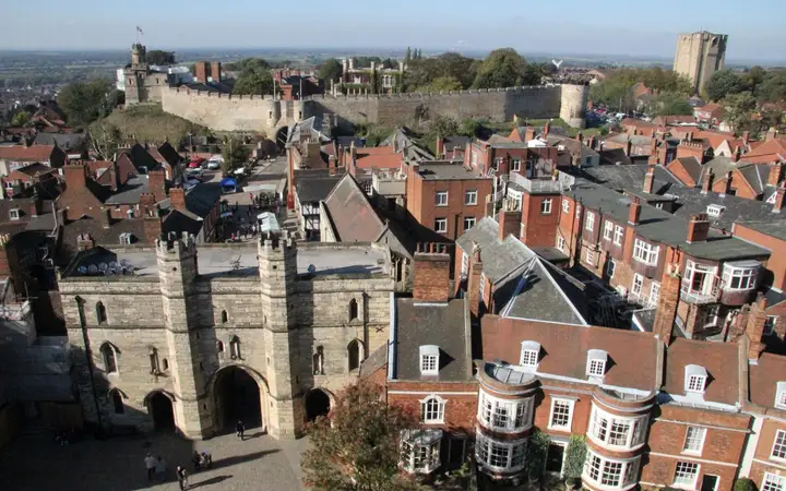 Lincoln Castle's walls above the old town roofs