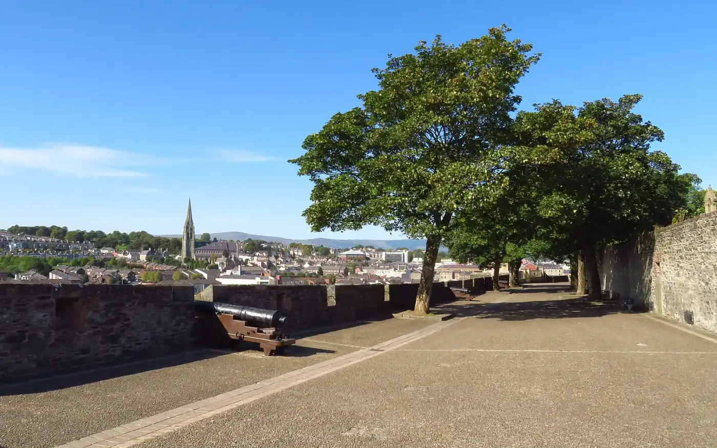 Derry's 17th-century city walls with a cannon and view over the city