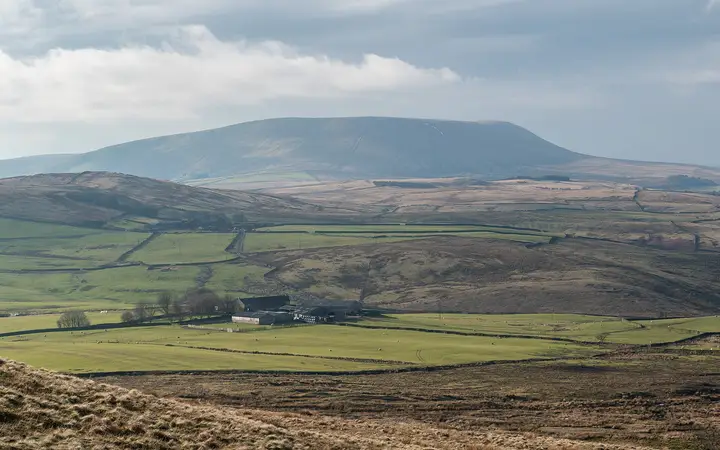 Pendle Hill's long summit across Lancashire fields