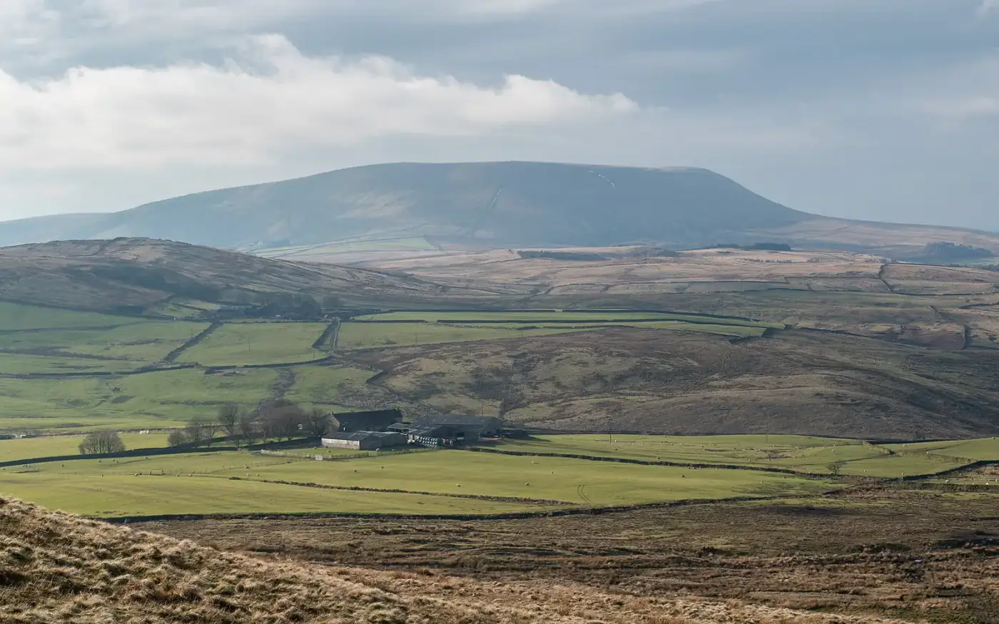 Pendle Hill's long summit across Lancashire fields