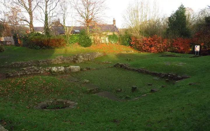 Low stone walls of the Roman bath house at Ribchester