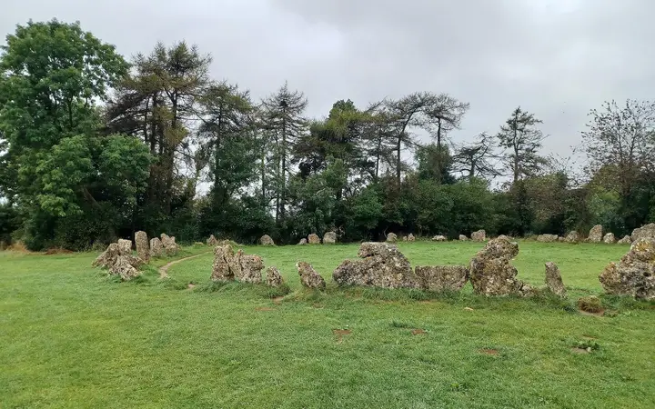 The King's Men stone circle at the Rollright Stones, a ring of weathered limestone pillars in grass