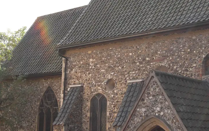 The small round-towered St Julian's Church in Norwich, with flint walls