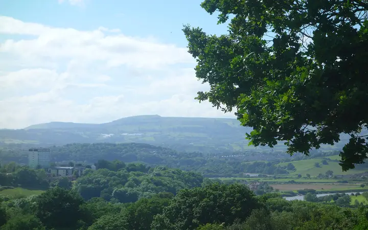 The rounded summit of Twm Barlwm above fields
